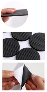 Detail of round black EVA foam furniture pad showing thick texture and adhesive backing