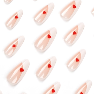French tip press-on nails with red heart patterns on a glossy natural pink base