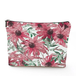 Detailed macro view of a floral linen toiletry bag featuring vibrant watercolor flower patterns
