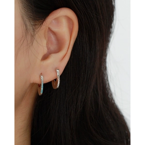 Vue rapprochée de boucles d'oreilles asymétriques en argent S925 avec pierres bleues