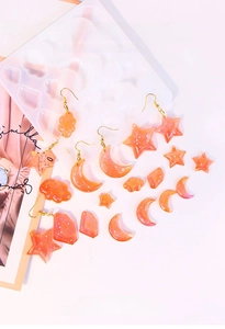 Detail showing orange resin star and heart earrings made from DIY silicone molds
