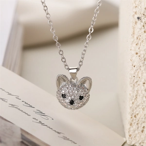 Close-up of a silver animal pendant necklace encrusted with sparkling white zircons