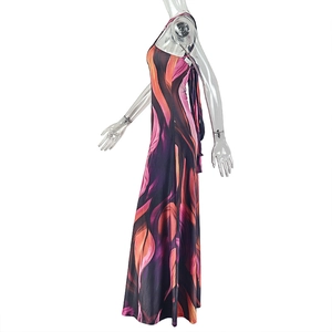 Side view of printed halter maxi dress with vibrant abstract flame pattern on white background