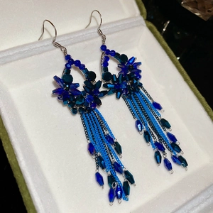 Detail of royal blue crystal teardrop earrings with long elegant chain tassels