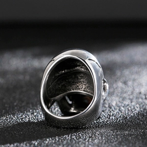 Macro detail of silver titanium steel skull ring showing inner band craftsmanship and texture