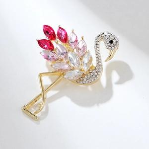 Close-up of pink crystal flamingo brooch with rose gold finish and sparkling rhinestones
