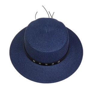 Top view of deep blue woven straw hat with black leather strap and star rivets