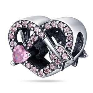 Macro shot of silver heart charm with pink crystals and S925 hallmark detail