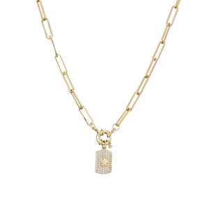 Macro view of gold paperclip chain and rectangle pendant with pavé cubic zirconia and star
