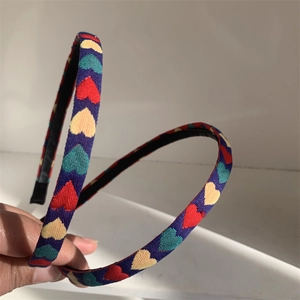 Detail of colorful heart pattern on fabric headband with high-quality textile texture