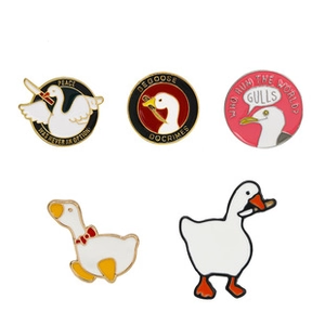 Detailed view of five funny enamel pins with goose and gull designs on white background