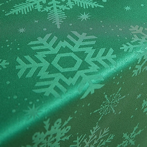 Green vintage Christmas tablecloth with elegant snowflake pattern and silky satin texture
