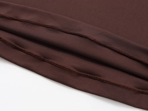 Macro shot of dark brown high-stretch fabric showing neat stitching and fine knit texture