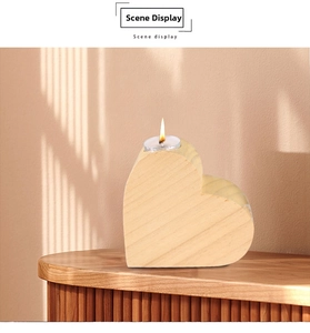 Close-up of heart-shaped pine wood candle holder with a tea light on a wooden cabinet