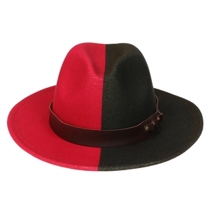 Detail of red and black bicolor wool felt fedora with brown leather band and metal studs