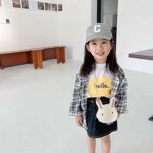 Little girl modeling grey rabbit shoulder bag with casual outfit in natural light