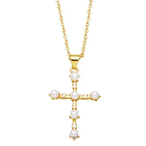 Elegant gold cross pendant necklace featuring white pearls and sparkling crystal stones