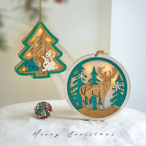 Lighted wooden Christmas tree and reindeer ornaments on snow for festive home decoration