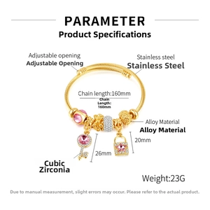 Detail view of adjustable gold charm bracelet with pink crystals and star lock pendant