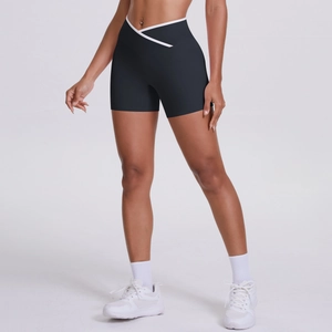 Detail of high-waist crossover V-shape waistband on black compression yoga shorts