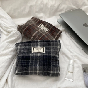 Macro view of vintage plaid wool cosmetic bags with Pleasant Time woven label