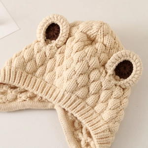 Chunky beige knitted baby hat with cute bear ears and soft warm texture for infants