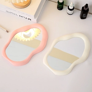 Irregular cloud-shaped makeup mirror with wavy frame in pink and cream white colors