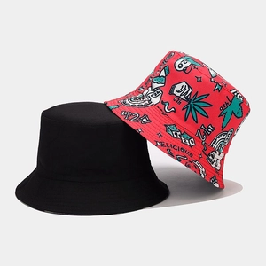 Flat lay of double-sided cotton bucket hats in black and vibrant red graffiti print