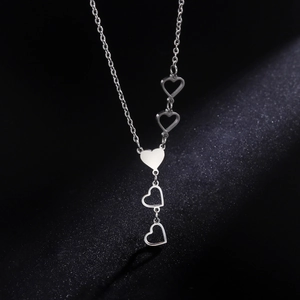 Polished silver stainless steel necklace featuring a solid heart and hollow charms