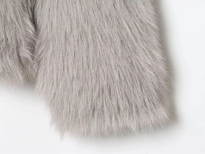 Close-up of premium gray faux fur hooded jacket showing soft plush texture and fibers