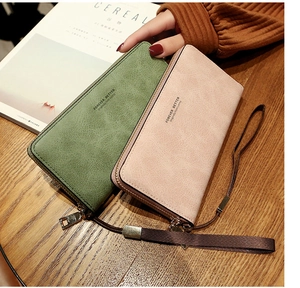 Close-up of long zip wallets in pastel green and pink PU leather with wrist straps