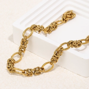 18K gold plated stainless steel Byzantine chain necklace on white geometric display stand