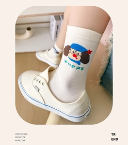 Detail of white cotton mid-calf socks with cartoon puppy motif and puppy text