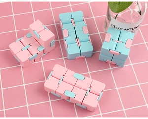 Pink and blue Infinity Cube sensory fidget toy showing various folding states in macro view