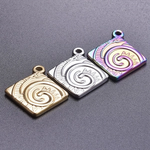 Macro view of square 18k plated stainless steel pendants with spiral engraving