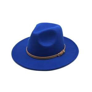 Close-up of royal blue fedora hat featuring a brown leather belt buckle band and gold clasp