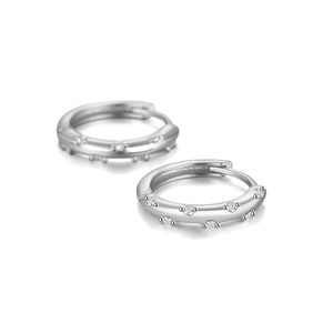 Detailed view of silver curved wave earrings with micro-pave white zircon stones
