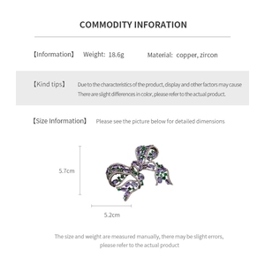 Detailed size chart of a copper bow brooch with purple and green zircons 5.7x5.2cm