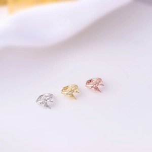 Detailed view of bird-shaped cartilage earrings in silver, gold, and rose gold with zircon
