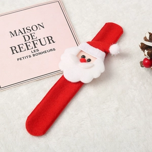 Detail of Christmas snap bracelet featuring a plush 3D Santa Claus on soft red fabric