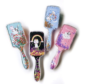 Detailed view of four transparent glitter hair brushes with cute cartoon animal prints