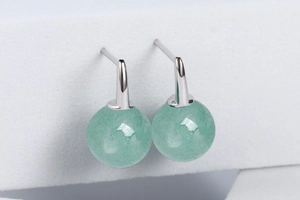 Macro detail of S925 silver drop earrings featuring elegant green aventurine round beads