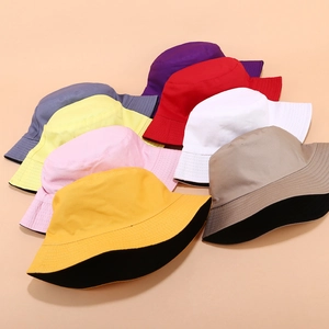 Solid color reversible cotton bucket hats in various shades for outdoor sun protection