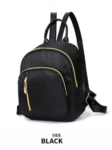 Minimalist black nylon waterproof backpack with golden zippers and side view perspective