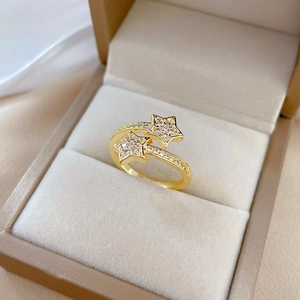 Gold open star ring with micro-set zircons displayed in a beige velvet jewelry box