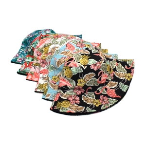Detailed close-up showing various flamingo and pineapple prints on cotton bucket hats