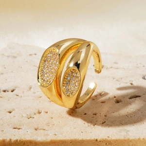 Detail of double-layer gold-plated ring with shimmering zircon insets on stone