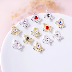 Detailed macro shot of 12 heart-shaped planet nail charms in gold and silver metal frames