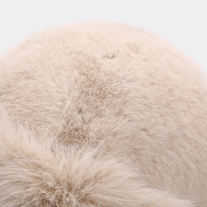 Macro detail of high-quality beige faux rabbit fur showing dense and soft plush texture