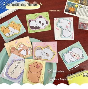 Detailed view of assorted 30-sheet sticky notes with cute animal shapes on a wooden desk